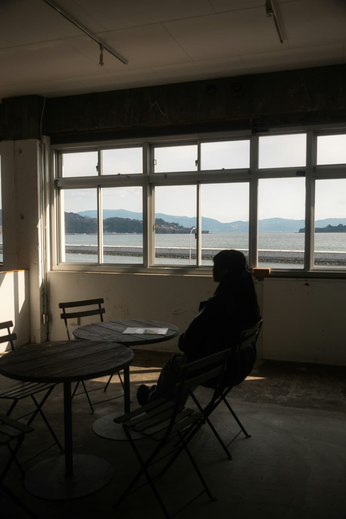 Person sitting alone replaying a conversation in their mind