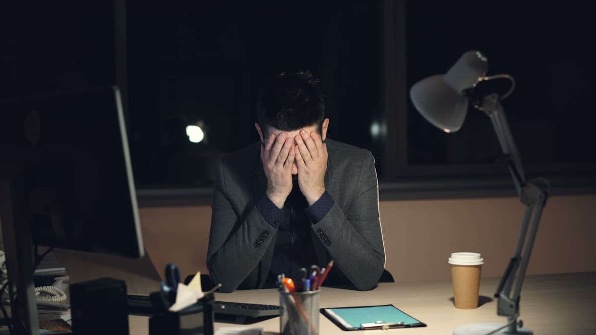 Person sitting at a desk with a clear, focused expression, symbolizing cognitive restructuring
